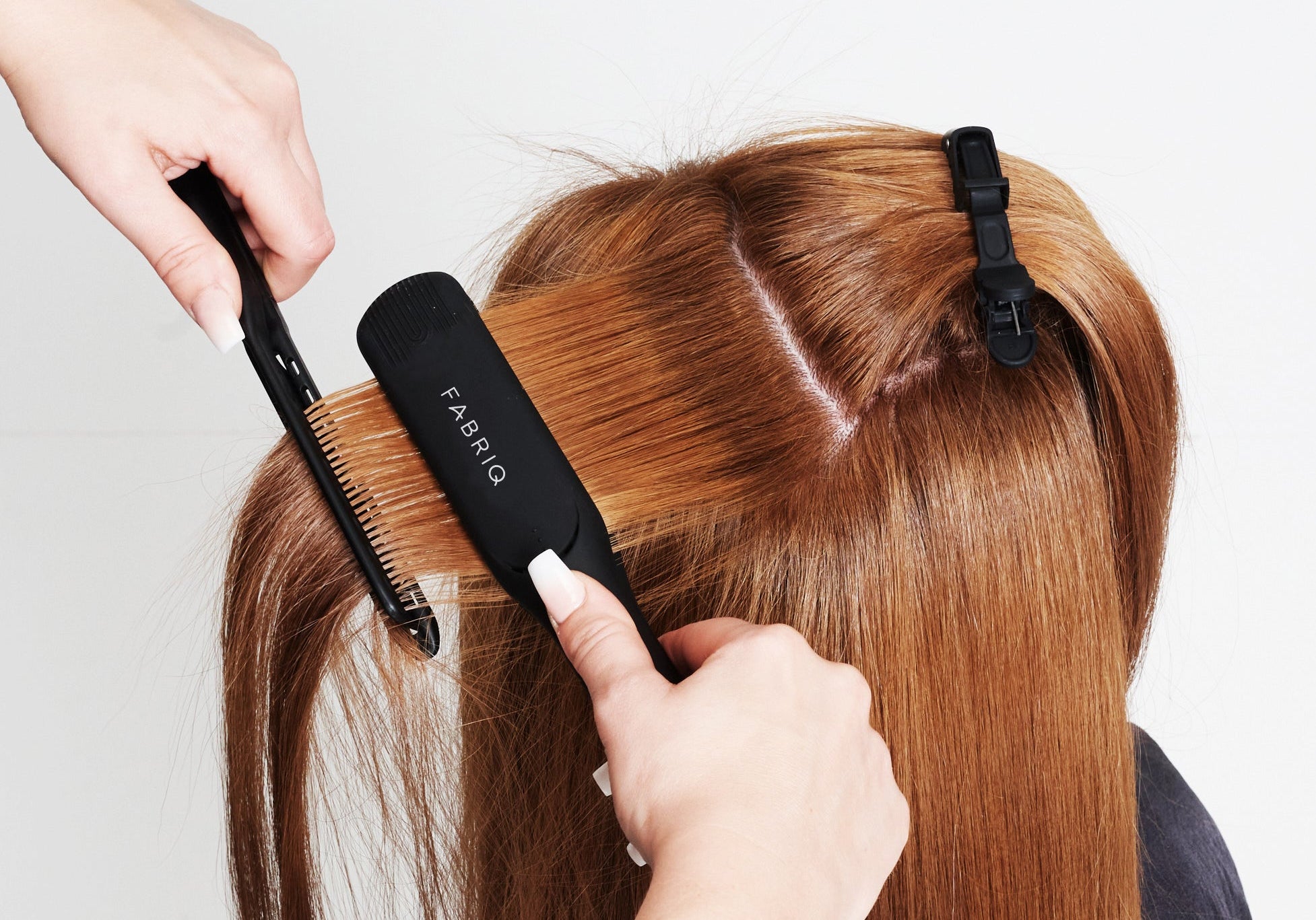 Hair being straightened with Fabriq irons