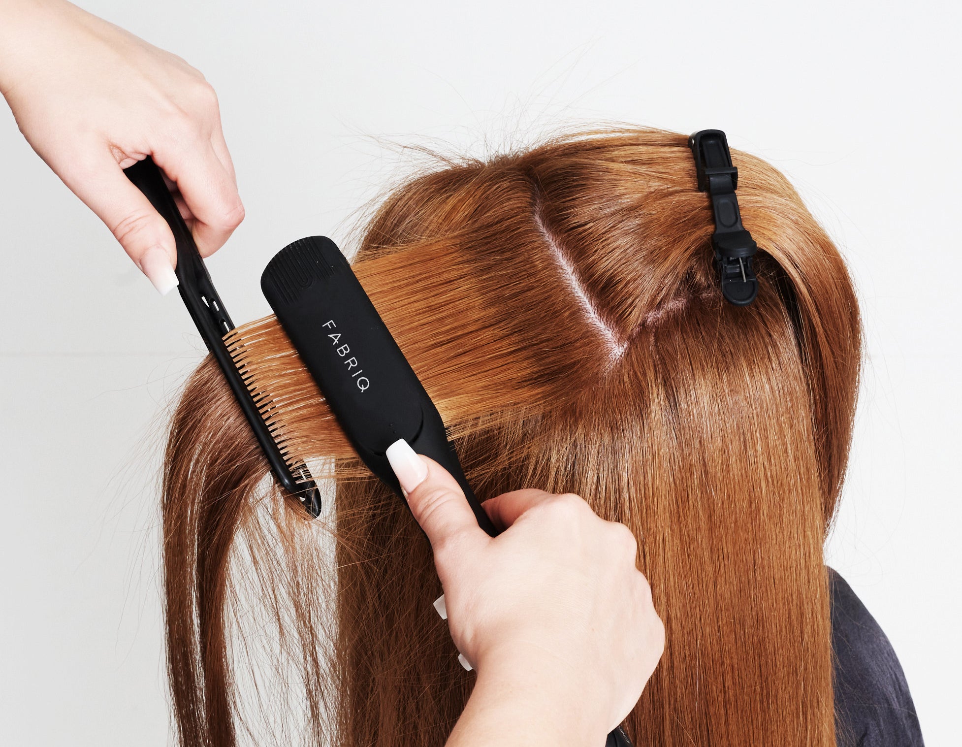 Hair being straightened with Fabriq irons